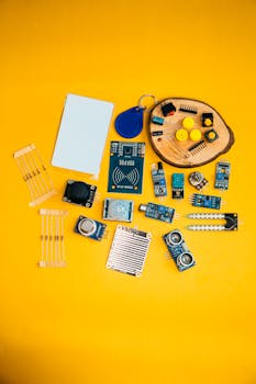 A collection of electronic components arranged on a vibrant yellow background, showcasing technology innovation.