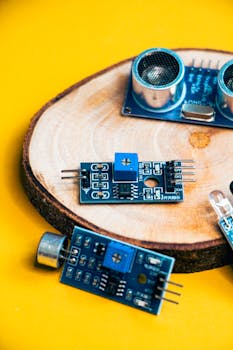 A close-up of electronic sensor modules on a wooden slice, ideal for tech visuals.