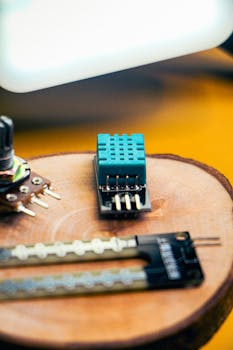 Detailed view of small robotics components placed on a wooden surface, ideal for tech innovation themes.