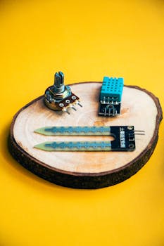 Close-up of electronic components on a wooden platform, showcasing innovation and technology.