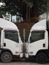 Symmetrical White Trucks in Urban Hong Kong