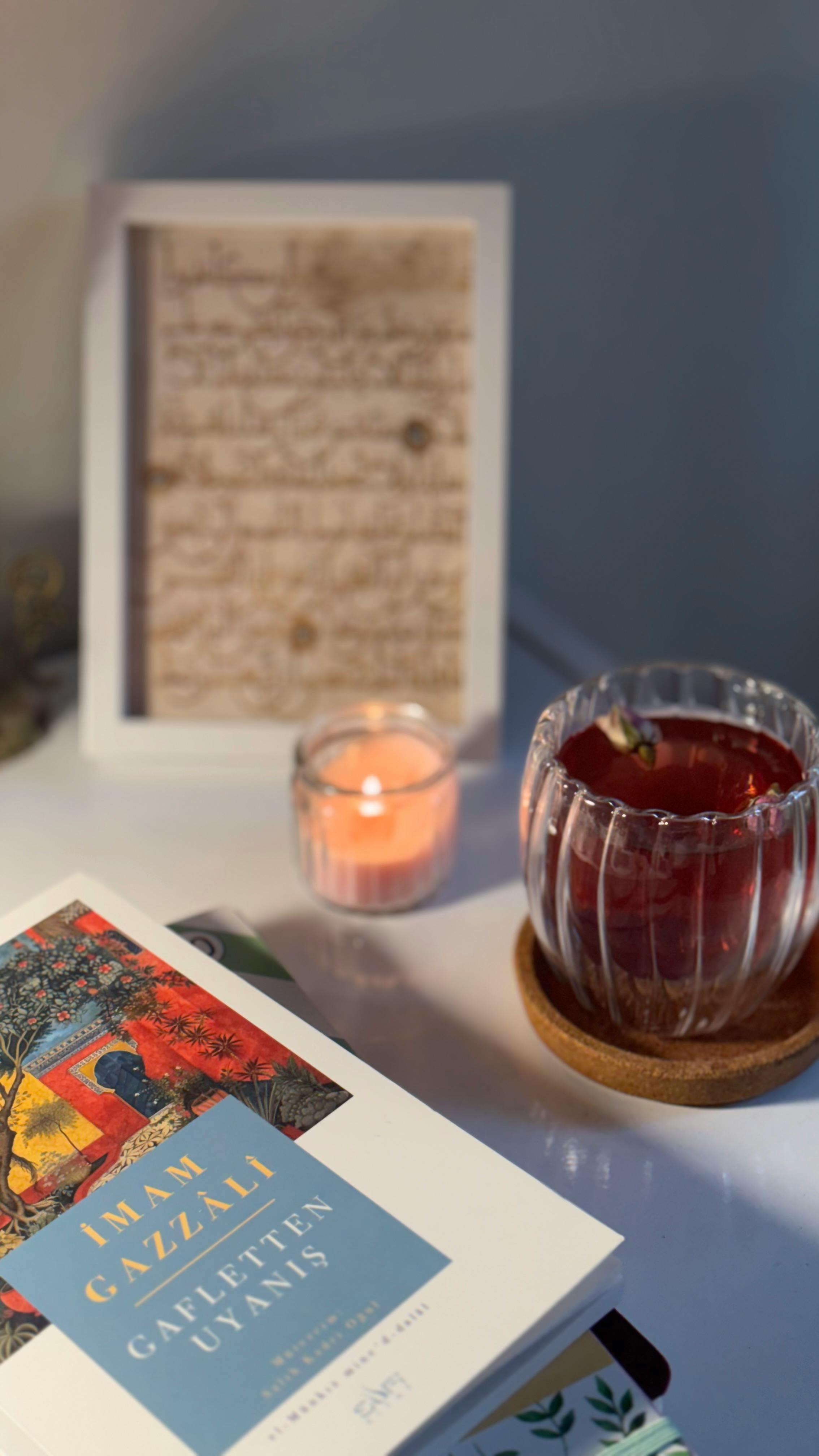 Charming scene of a book, candle, and apple in a peaceful reading nook.