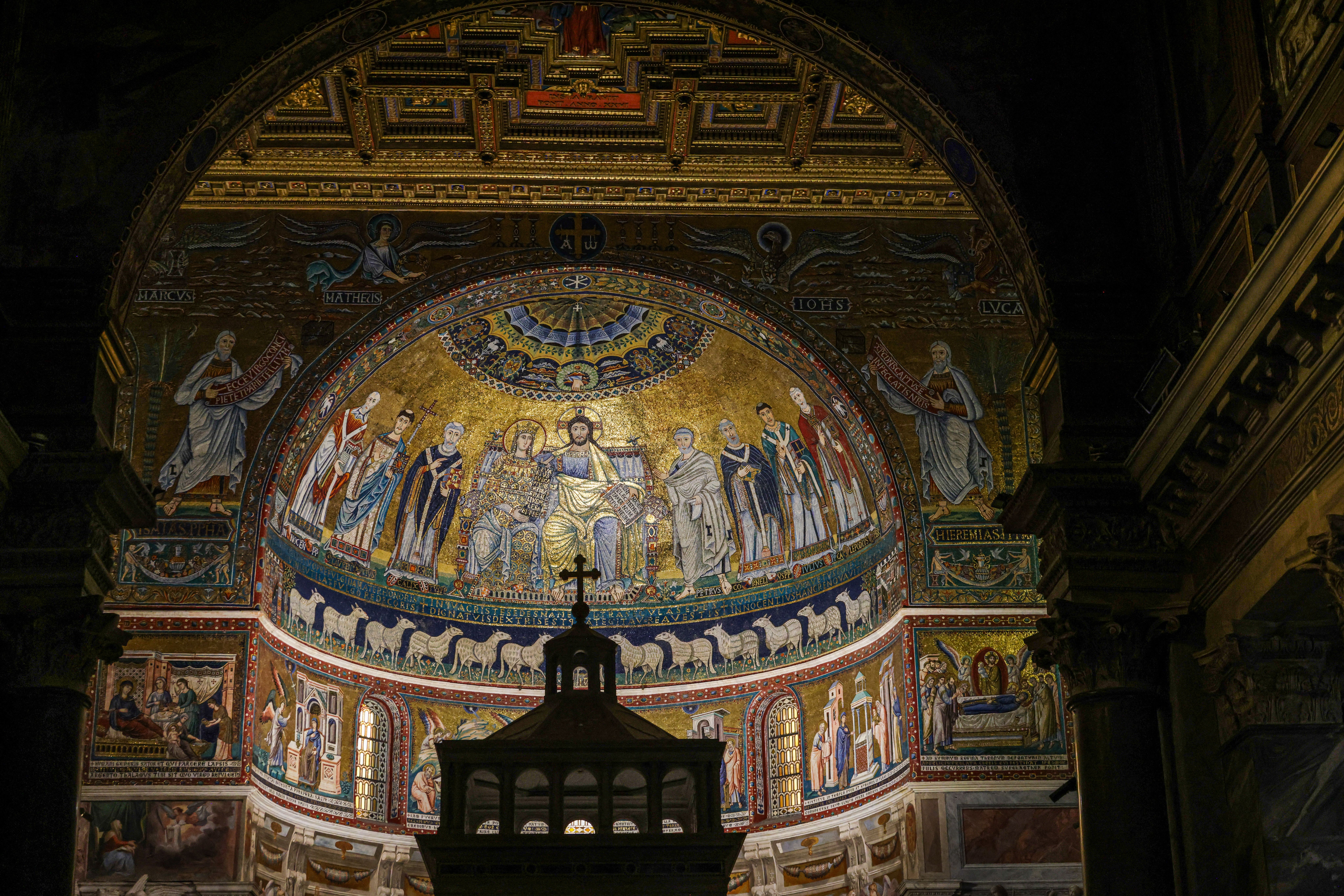 Intricate mosaic art depicting religious figures inside a grand cathedral.