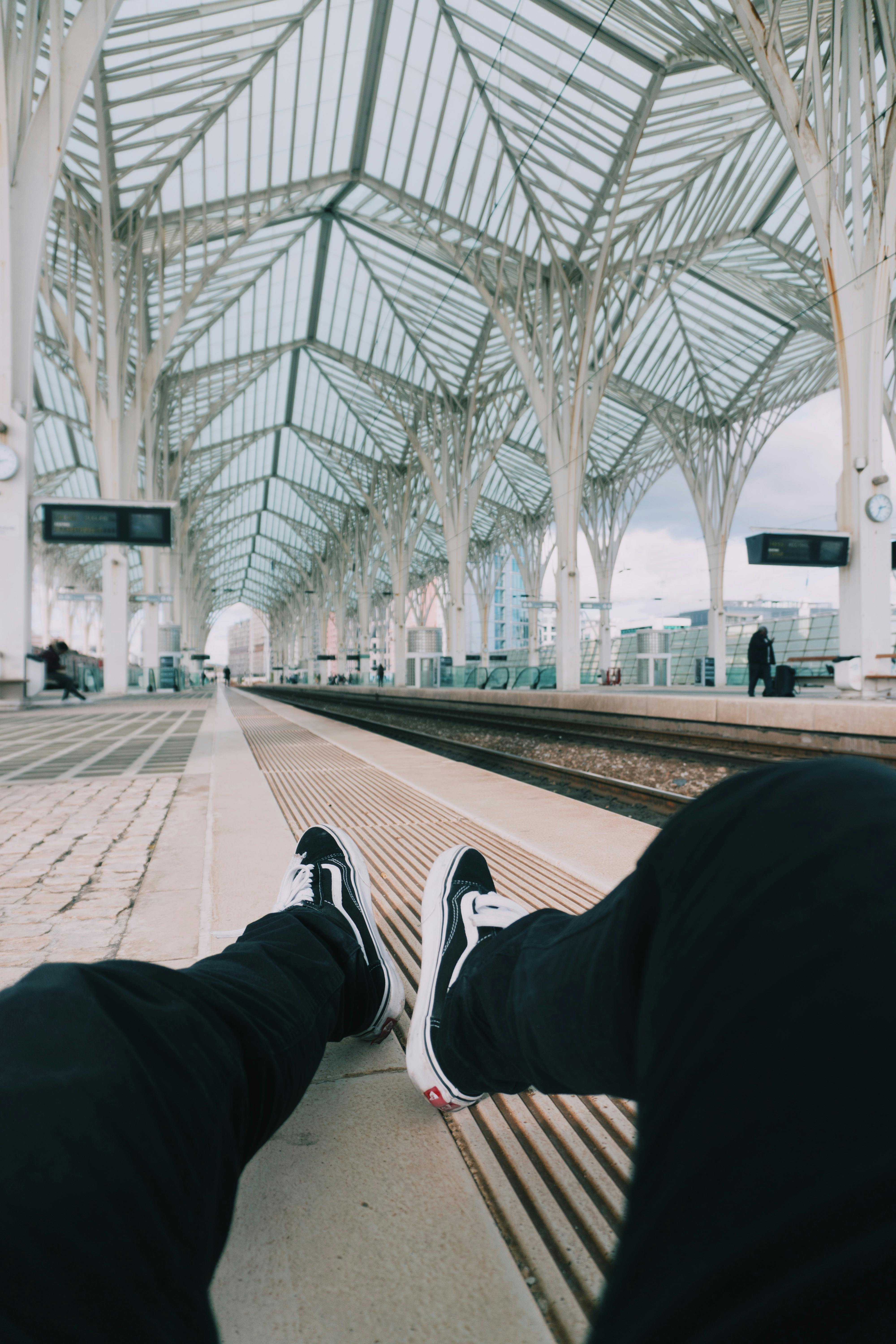 person sitting near railway