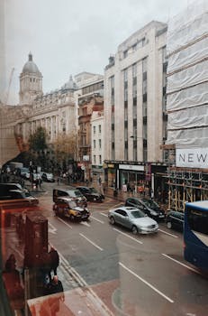 Crowded urban street scene in London featuring busy traffic and historic architecture.
