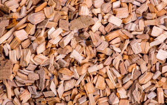 Detailed close-up shot of natural wooden chips, showcasing texture and earthy tones.