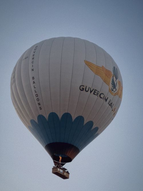 Free Güvercin hot air balloon gracefully ascending in a serene, clear sky. Stock Photo