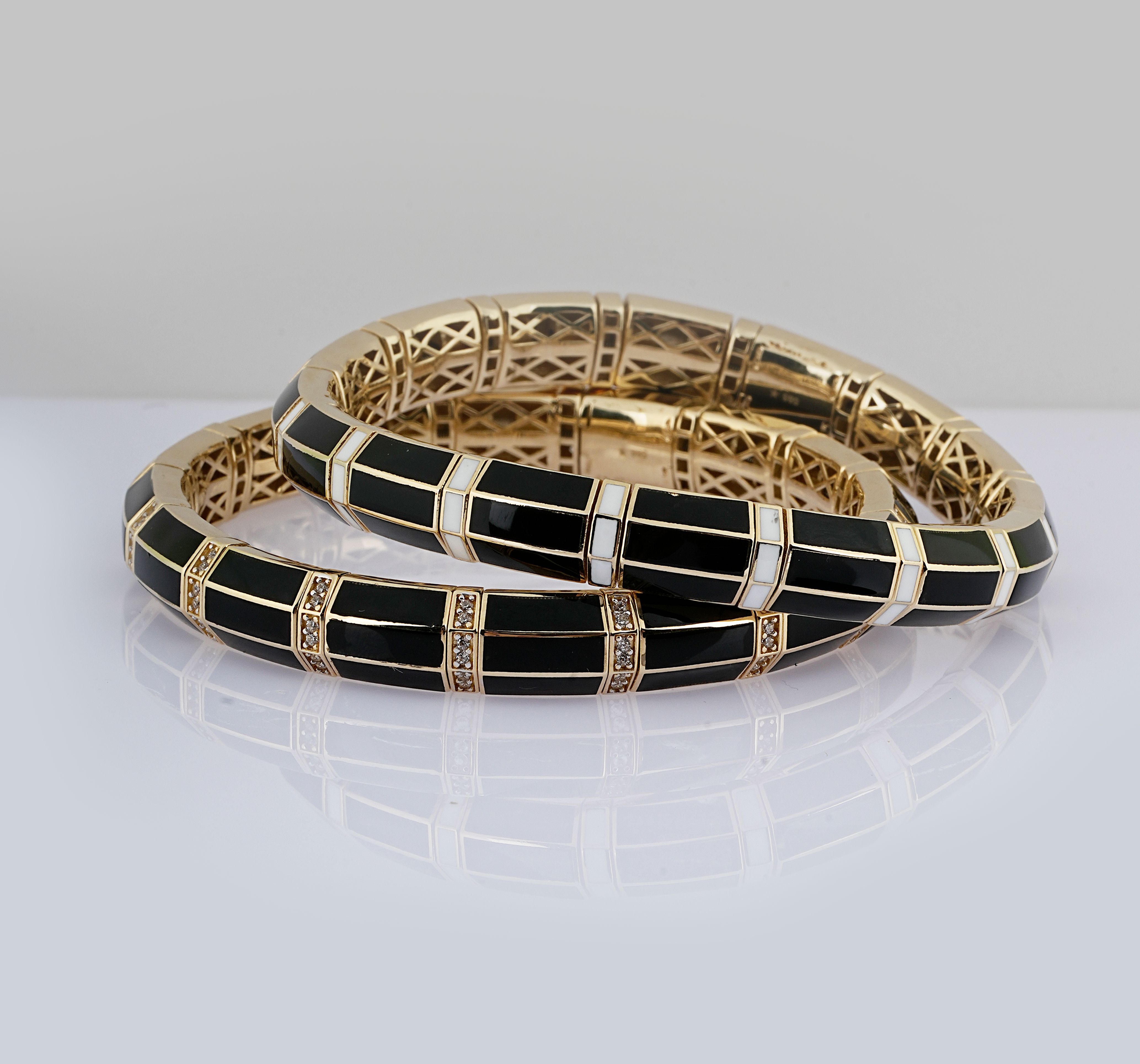 Sophisticated gold bracelets with black enamel design, perfect for fashion and elegance.