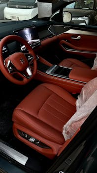Modern car interior with red leather seats and advanced tech dashboard for a luxurious feel.