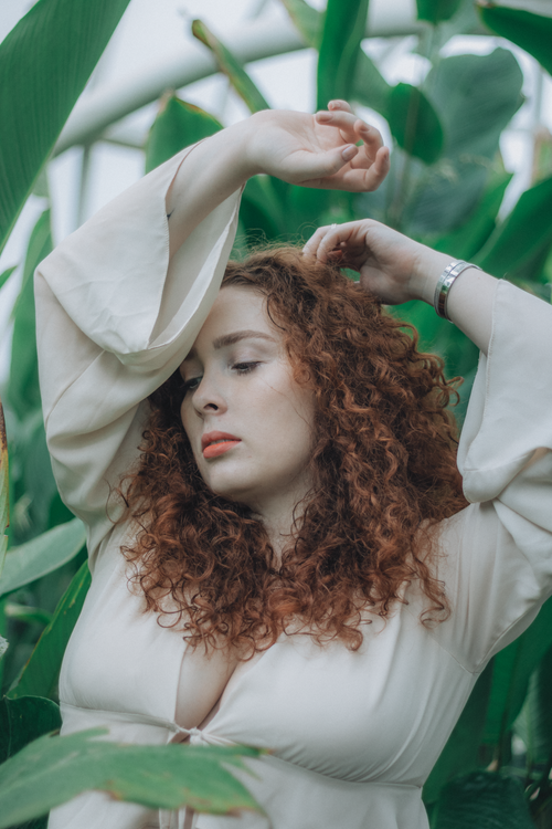 Nature Portrait of a Woman with Curly Red Hair · Free Stock Photo