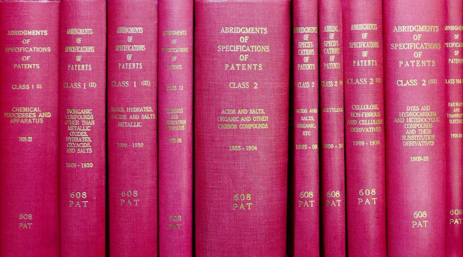 Row of red hardcover legal volumes on a shelf, the statute behind the clause
