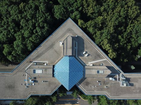 Drone shot featuring a modern architectural building amidst greenery in Plymouth, Minnesota.