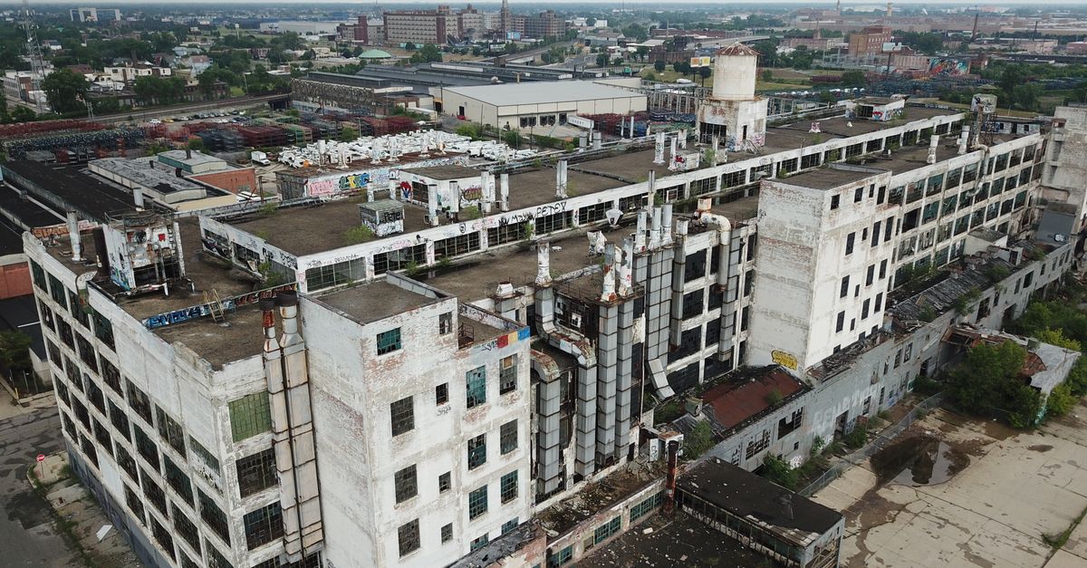 Drone shot of a large, abandoned industrial building in Detroit, Michigan.
