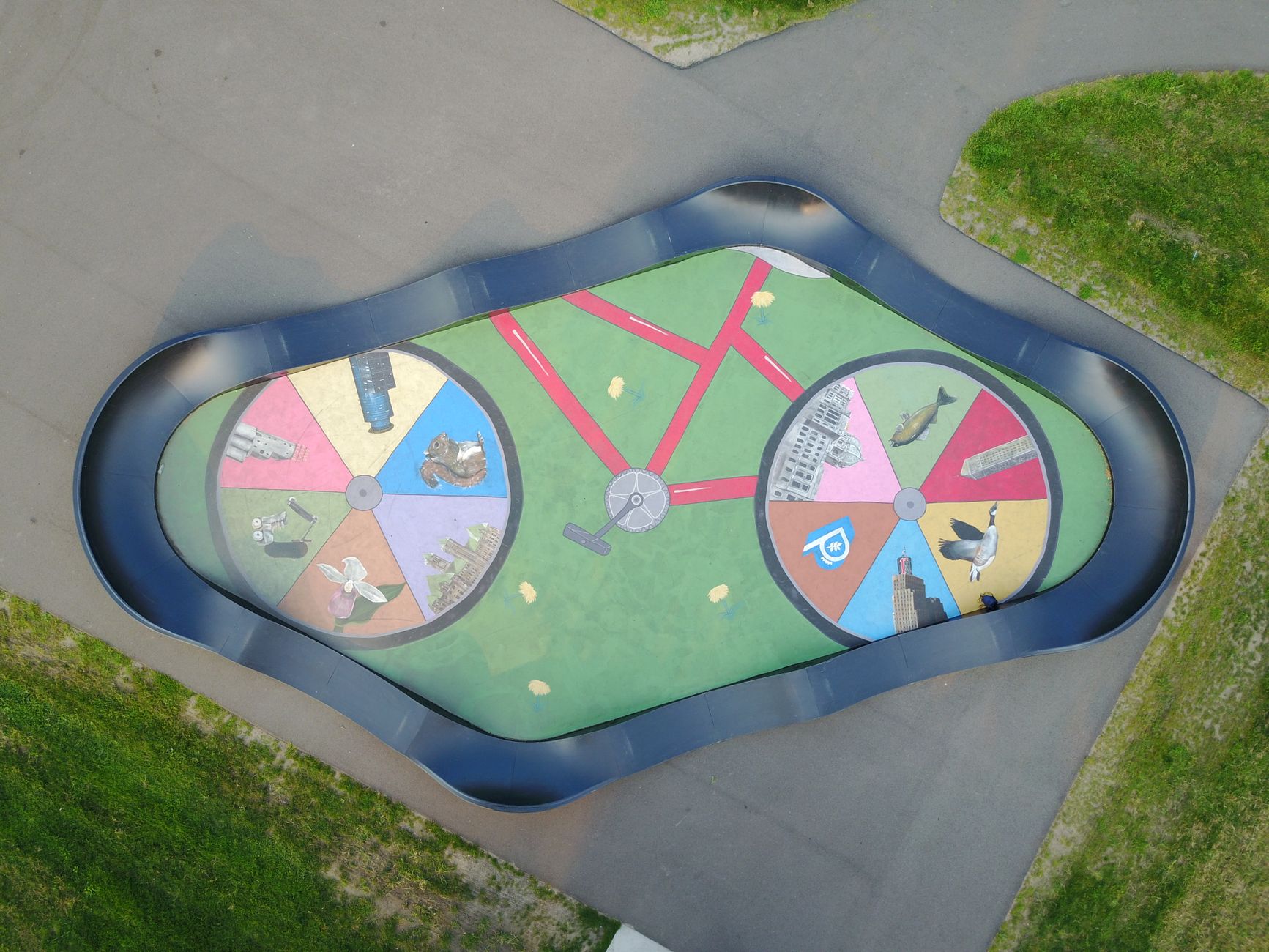 Aerial shot of a vibrant bike pump track with artistic design in Plymouth, Minnesota.