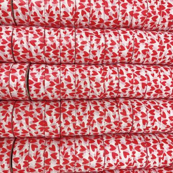 Stacked rolls of washi tape with red heart patterns, perfect for crafts and decoration.（イメージ）