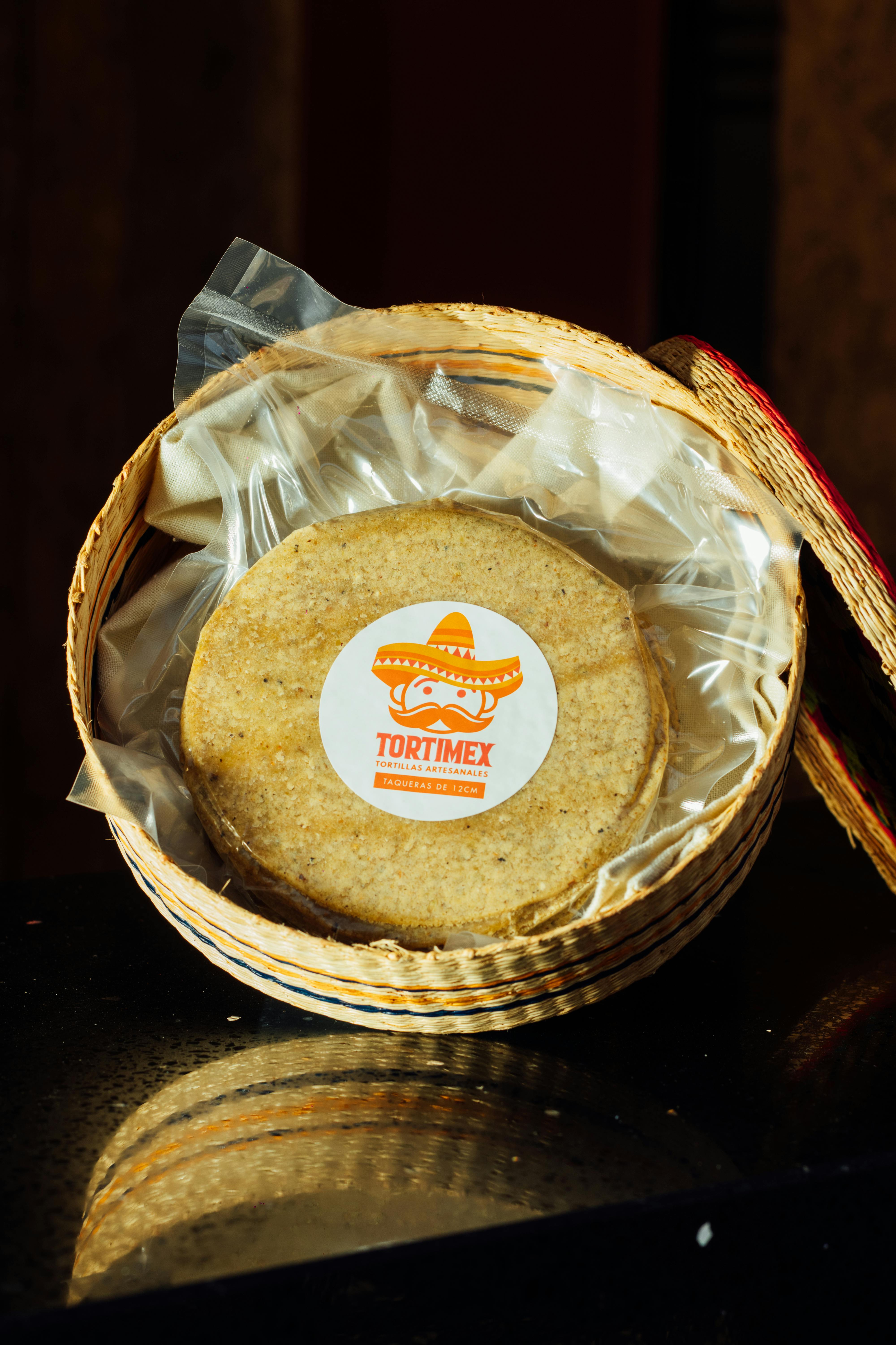 High-quality corn tortillas packaged in a woven basket; perfect for authentic Mexican cuisine.