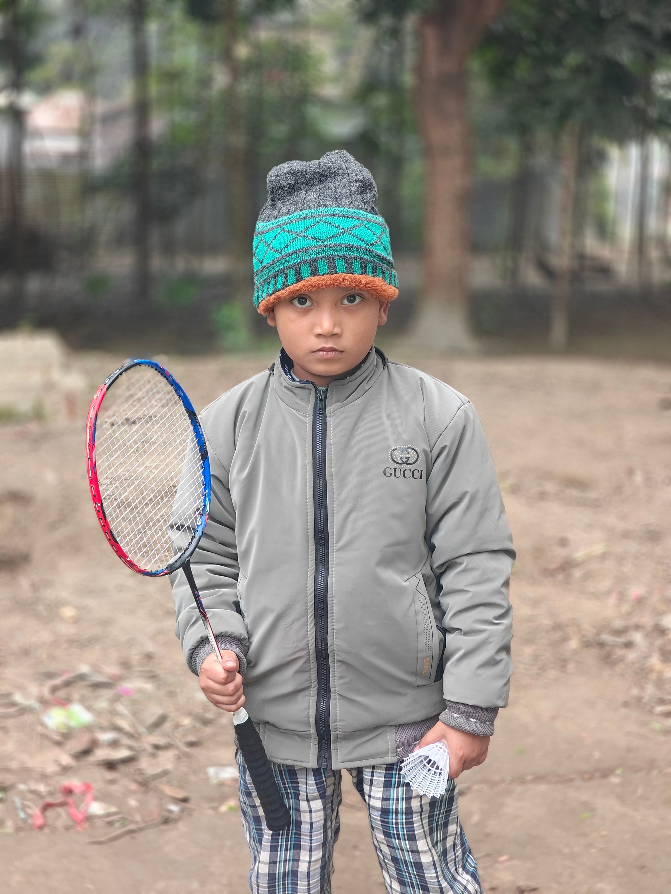 Young Boy Holding Badminton Racket Outdoors · Free Stock Photo
