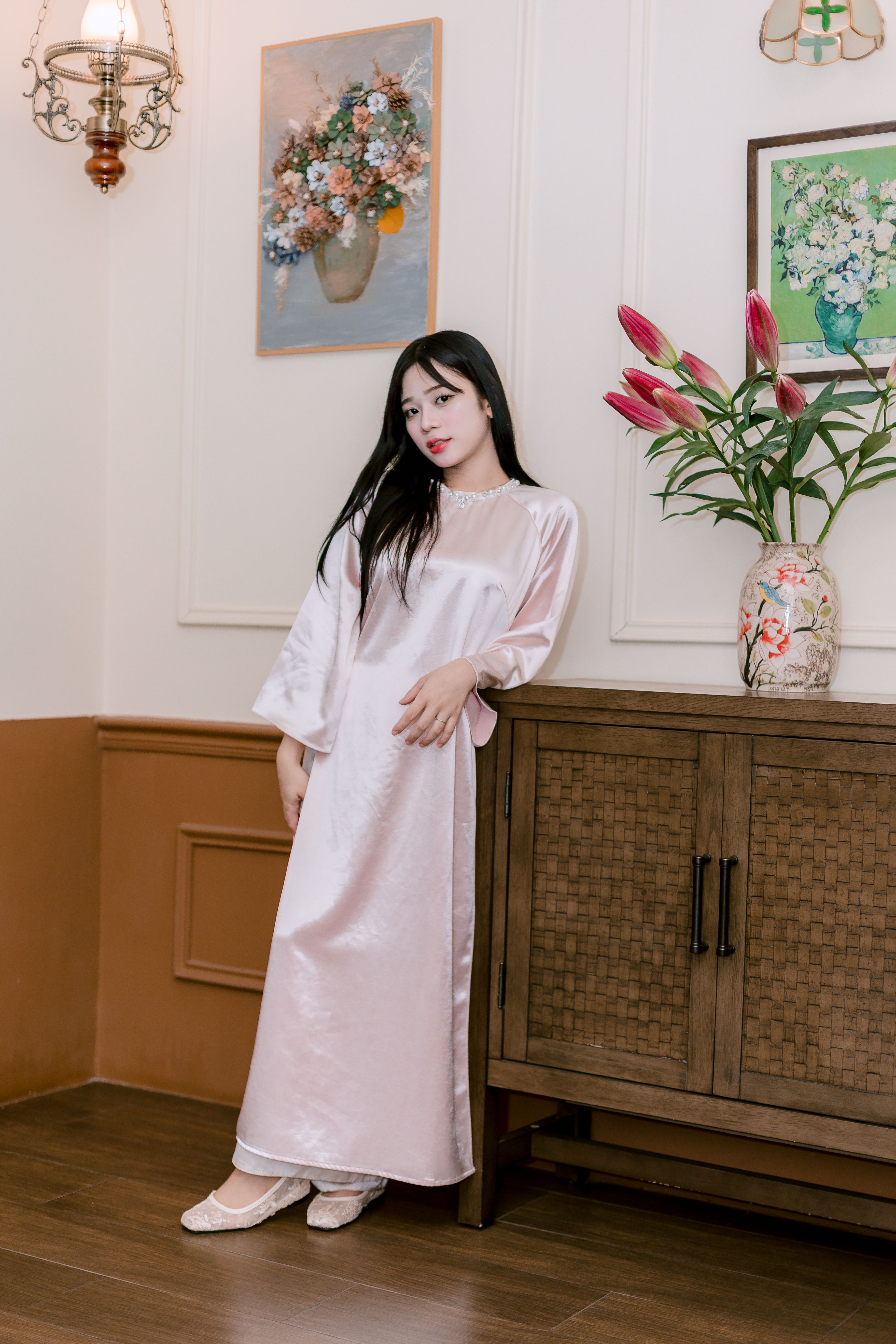 Elegant Woman in Silk Dress Leaning Against Cabinet · Free Stock Photo