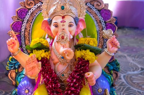 Free Brightly colored Ganesh idol adorned with flowers, capturing the essence of Ganesh Chaturthi in Mumbai. Stock Photo