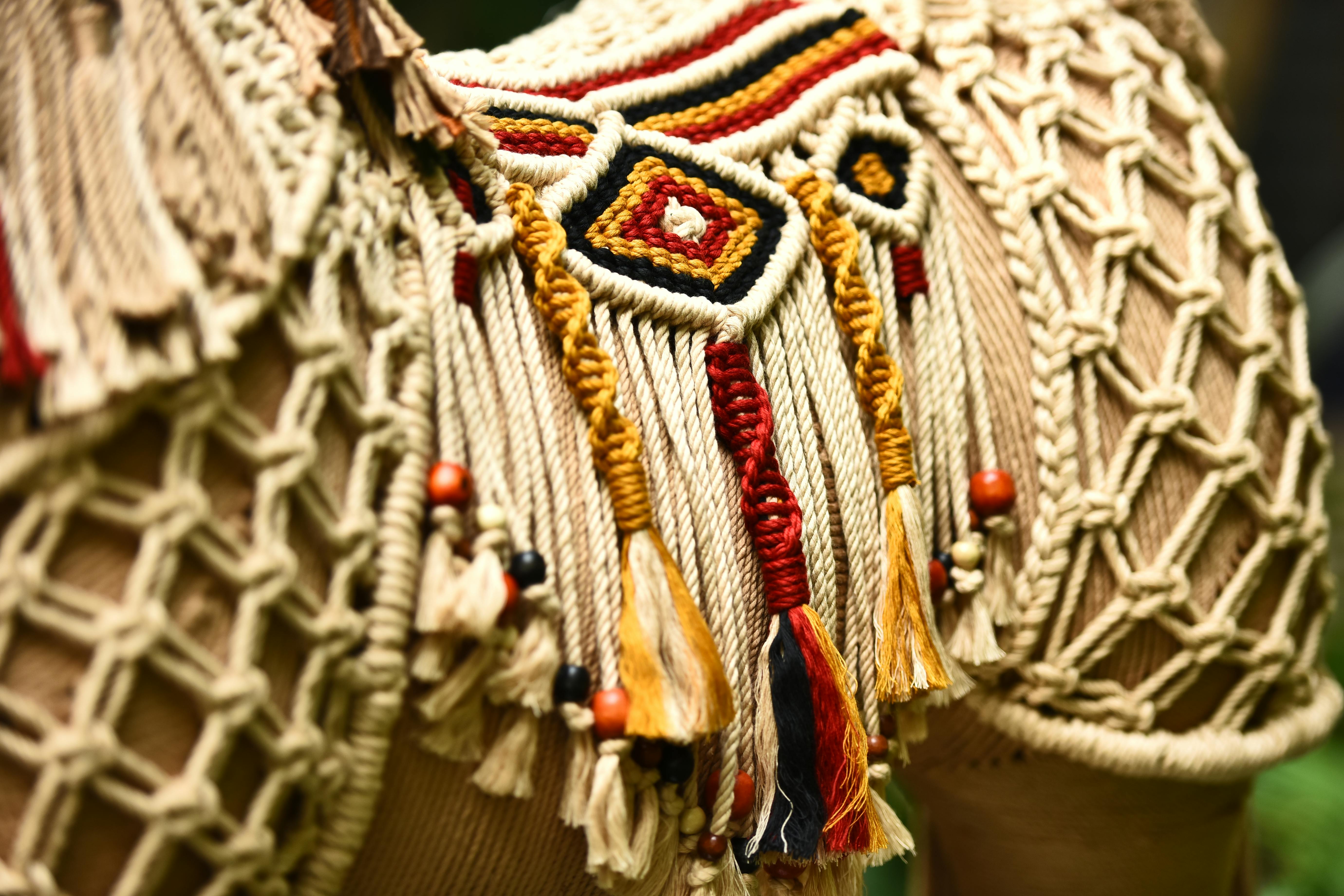 Colorful woven tribal textile art — mola-inspired patterns