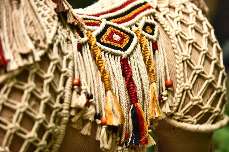 Colorful woven tribal textile art — mola-inspired patterns