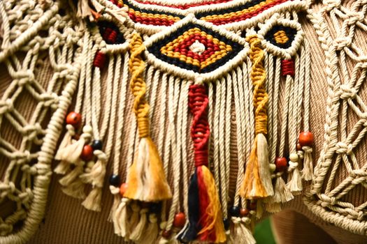 Intricately designed macrame wall hanging with colorful patterns and beads.