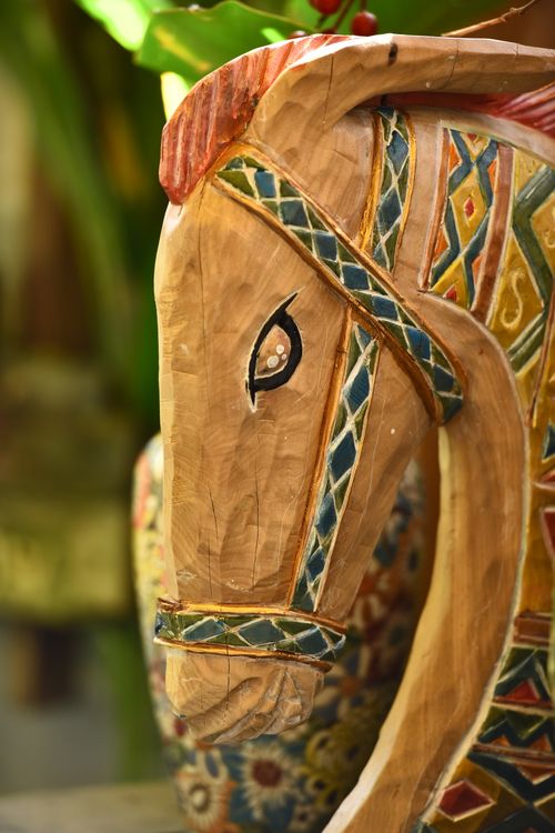 Free Close-up of a colorful, intricately carved wooden horse statue with geometric patterns. Stock Photo