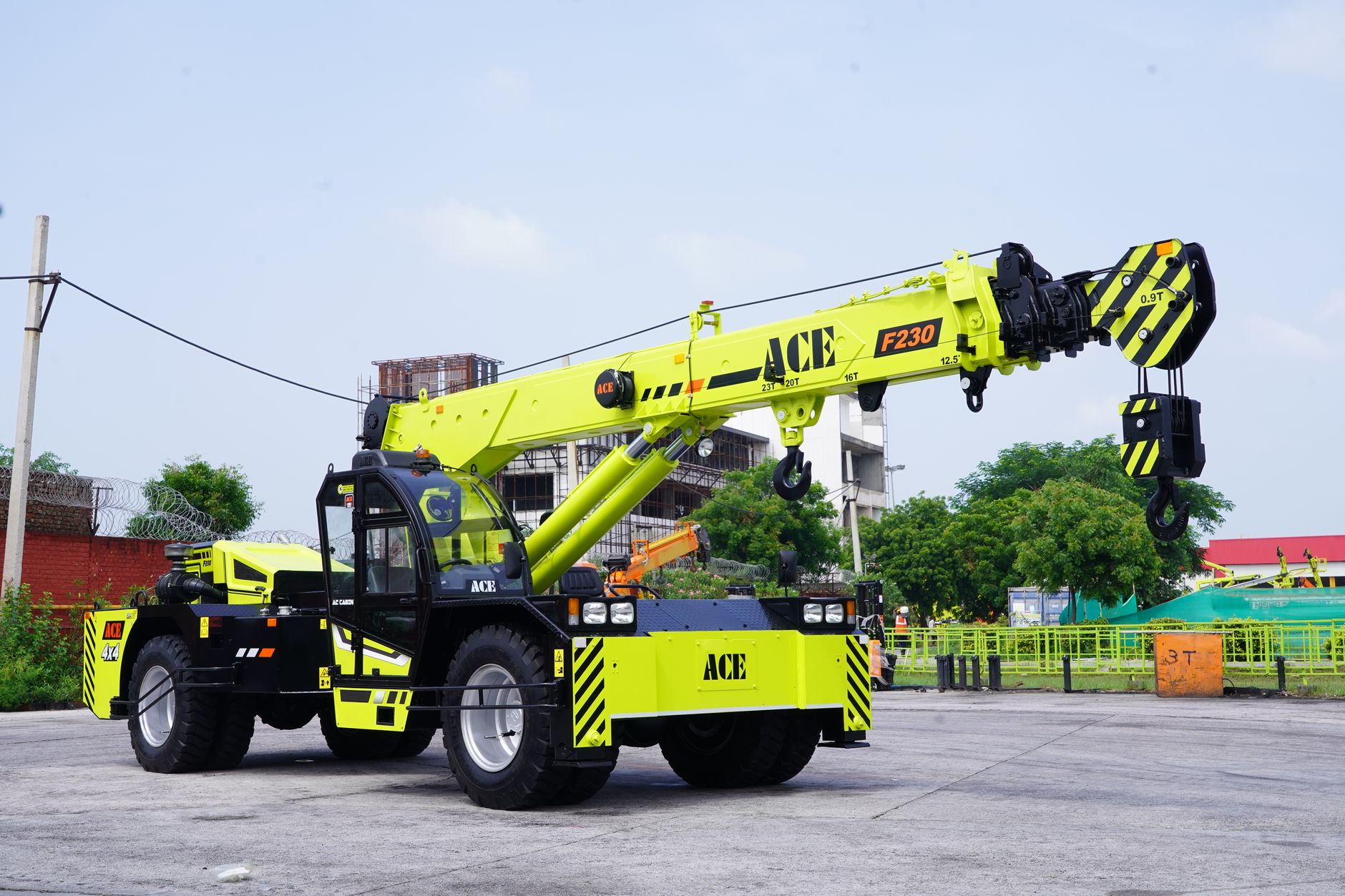 Bright yellow ACE F230 mobile crane at an industrial site in Faridabad, India.