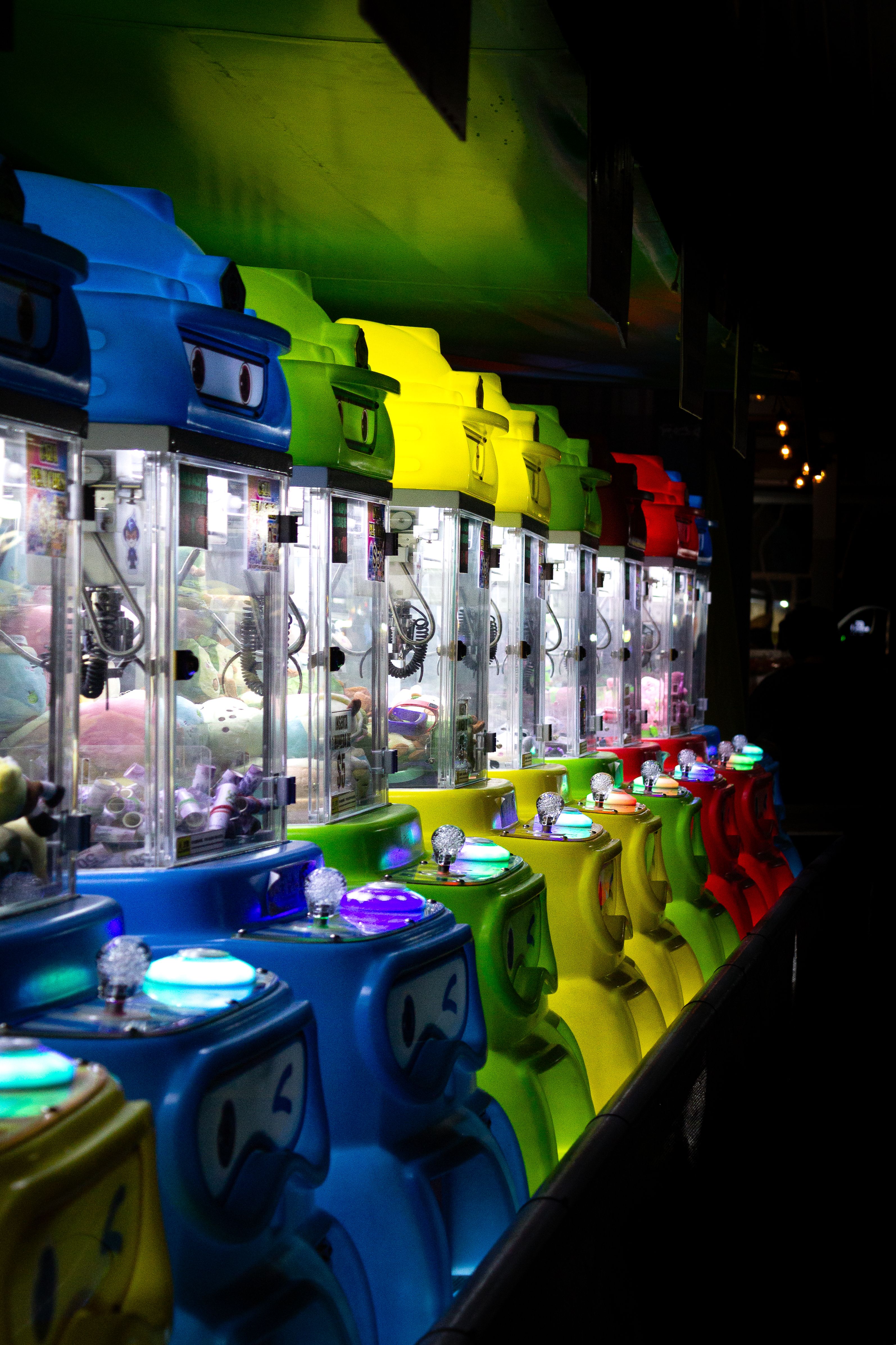 Vibrant Arcade Claw Machines at Night · Free Stock Photo
