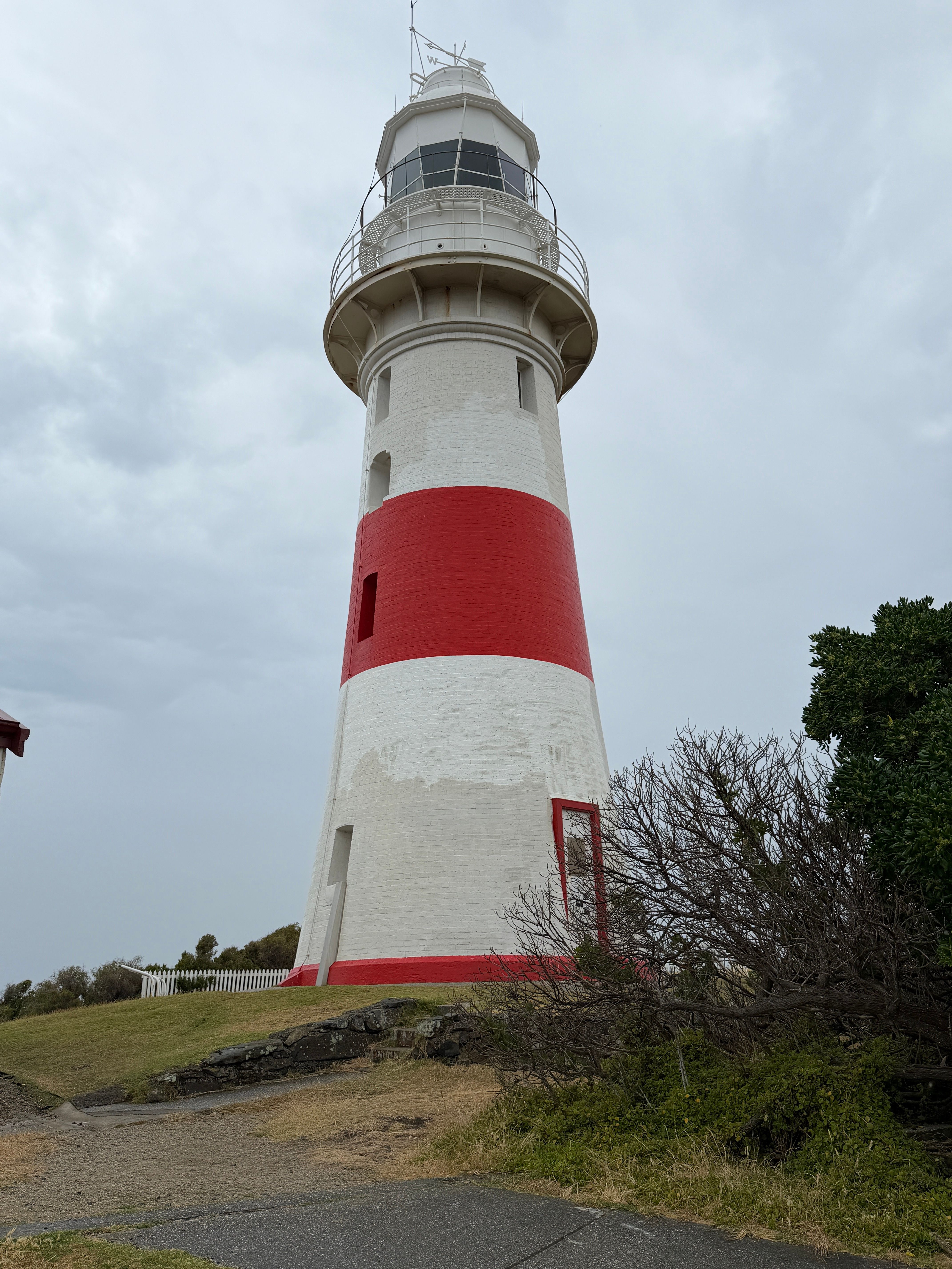 Red and White Lighthouse Under Cloudy Sky · Free Stock Photo