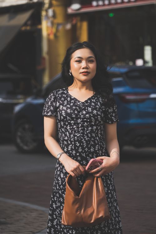 Stylish Woman Posing on Urban Street in Floral Dress · Free Stock Photo