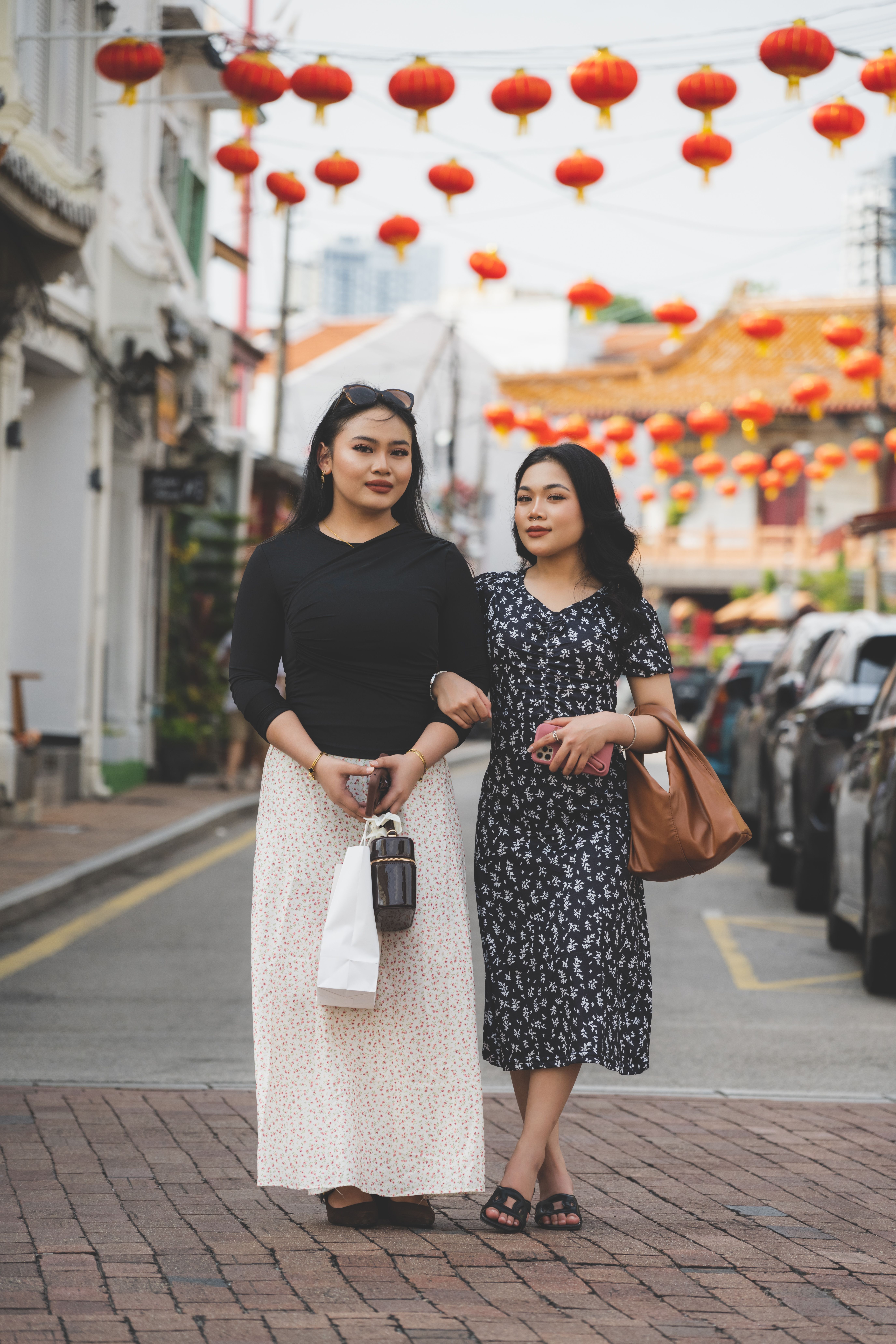 Two Women Walking Under Chinese Lanterns
