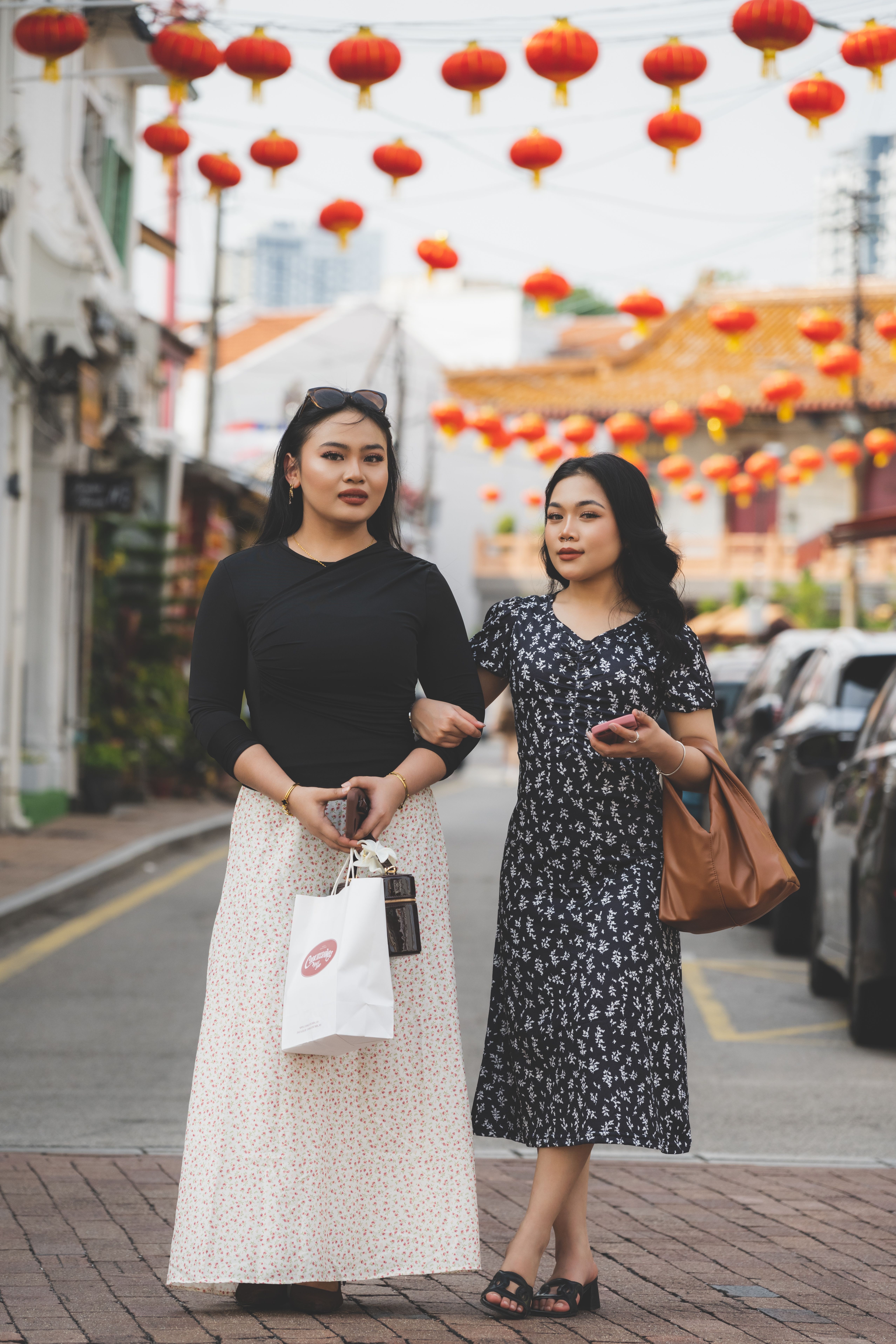 Women Strolling Amidst Festive Red Lanterns