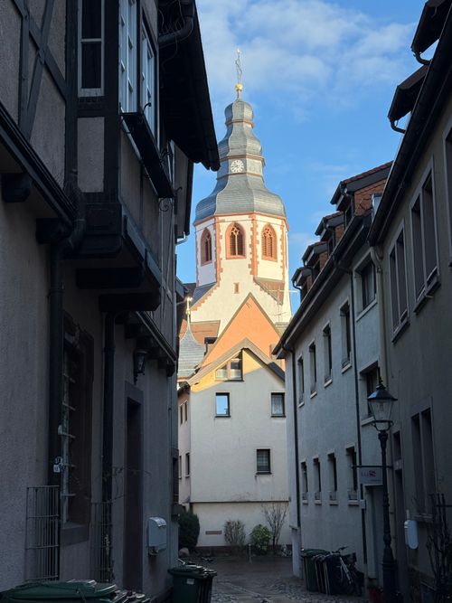 Free Picturesque alley leading to a historic tower, a perfect blend of medieval architecture and charm. Stock Photo