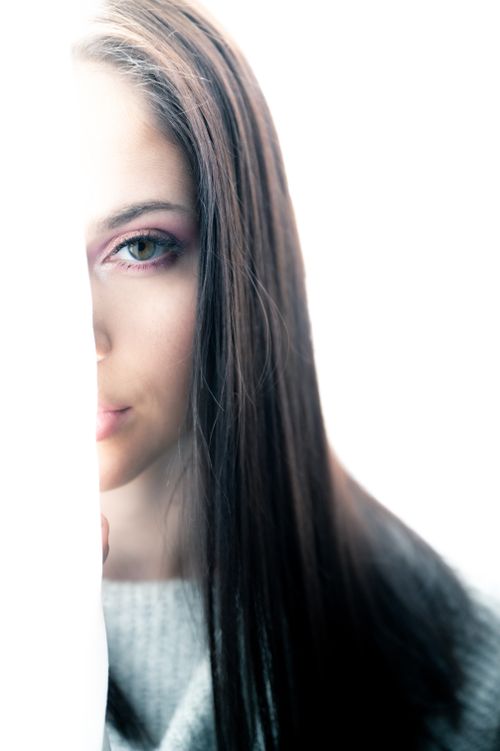 Free A striking portrait with a focus on the woman's green eyes and long hair, creating a mysterious ambiance. Stock Photo