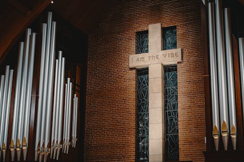 White Cross on Brown Brick Wall