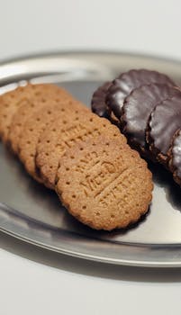 Delicious selection of plain and chocolate biscuits displayed on a metal tray.