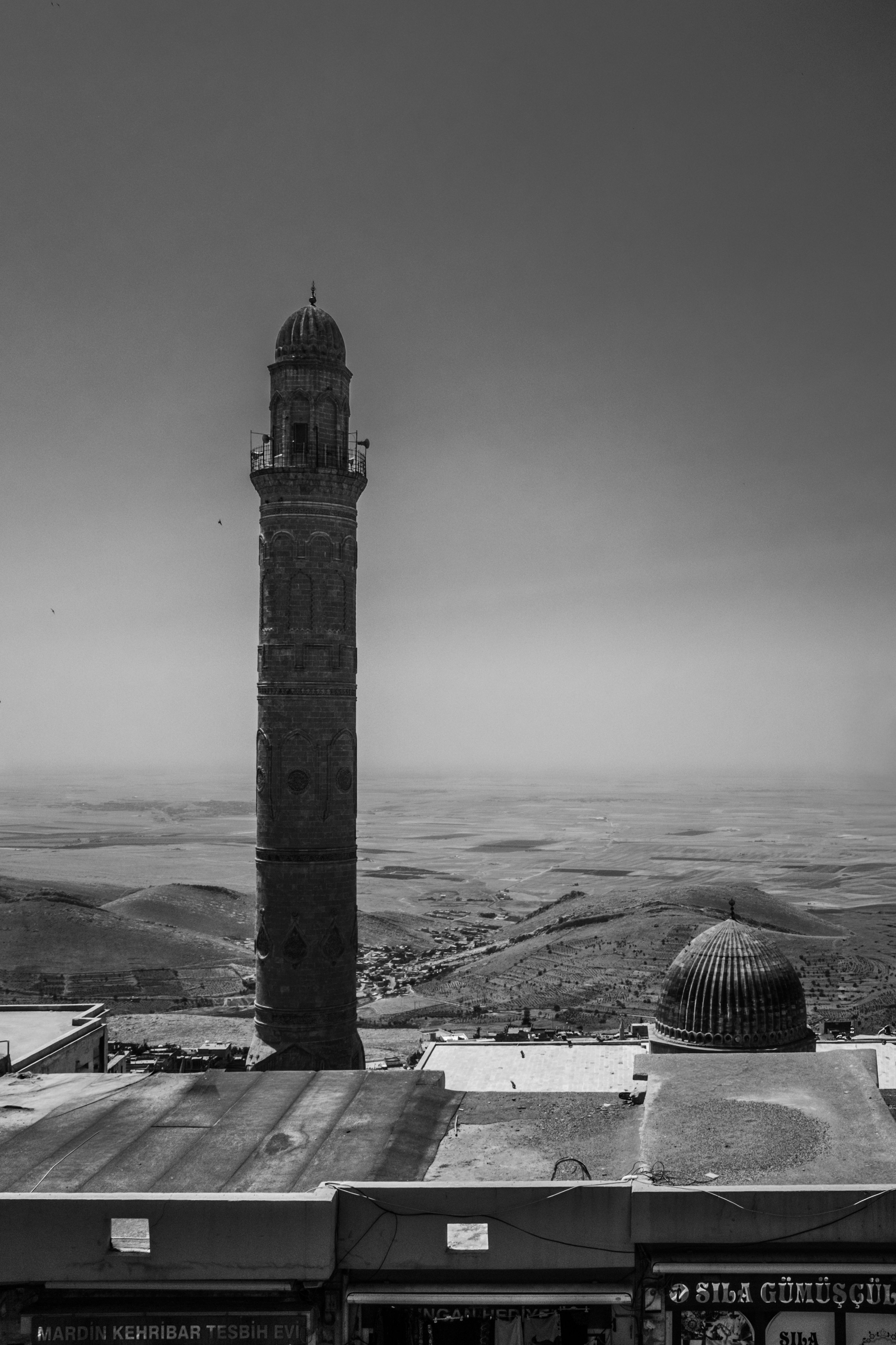 Black and white photograph showcasing the iconic minaret in Mardin, Turkey.