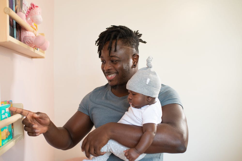 Man carrying his baby. | Photo: Pexels