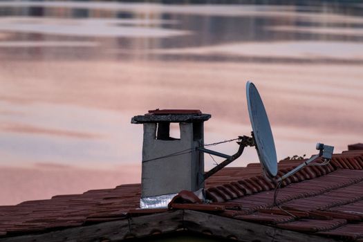 A satellite dish installed on a remote home roof to provide reliable satellite connectivity.