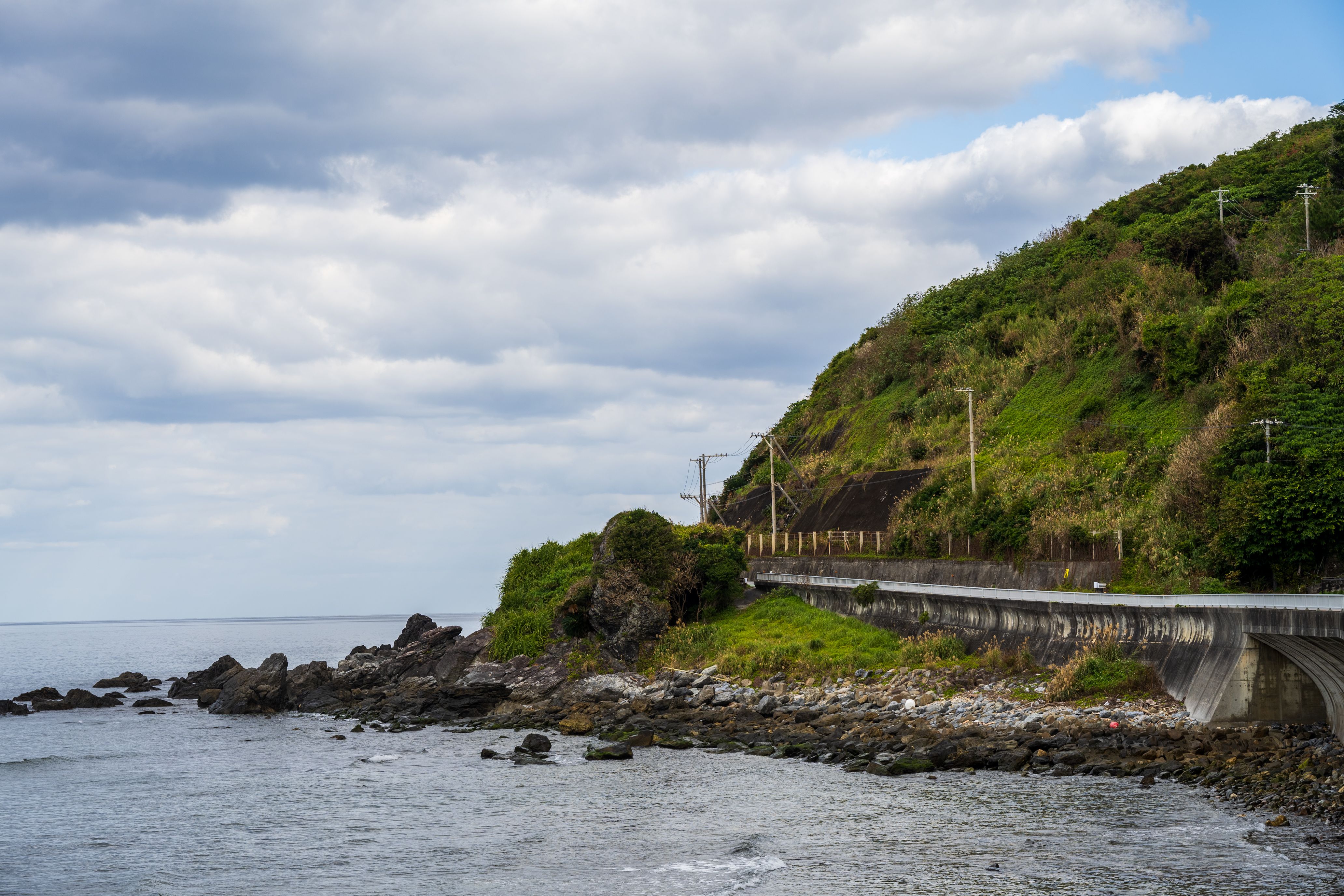 Scenic Coastal Road Along Rocky Shoreline · Free Stock Photo