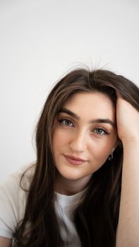 Close-up portrait of a young woman with long dark hair in a relaxed pose.