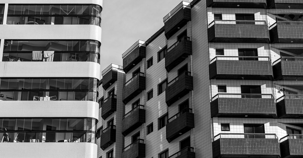 Monochrome photo of high-rise residential buildings showcasing modern architecture and balconies.