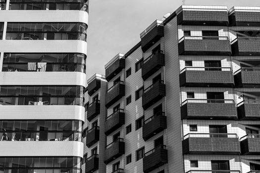 Monochrome photo of high-rise residential buildings showcasing modern architecture and balconies.