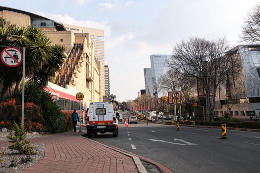 A vibrant street view of Johannesburg featuring modern architecture and city life.