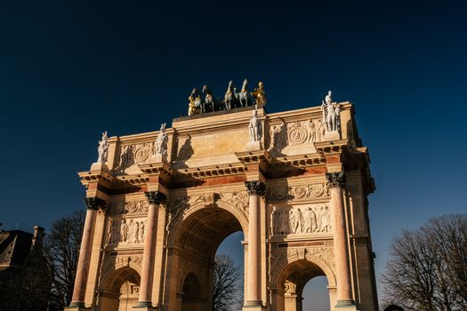 Stunning view of Arc de Triomphe du Carrousel in Paris under a deep blue sky.