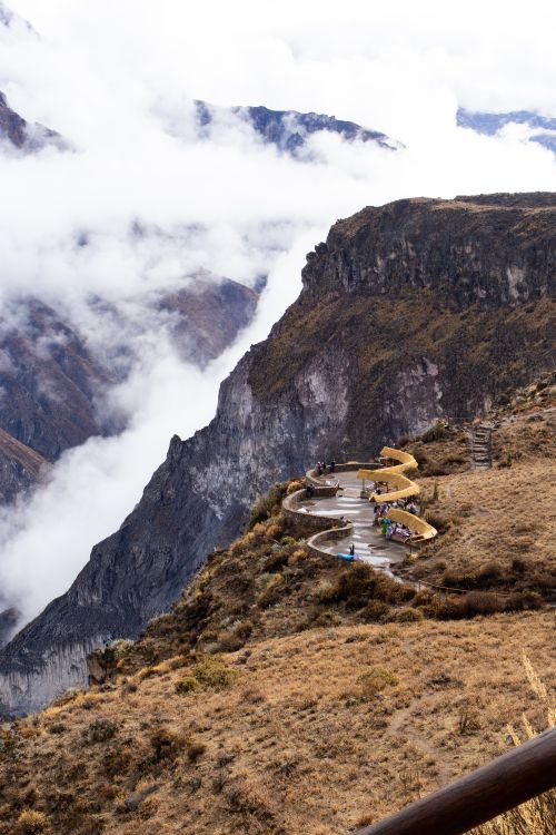 Free Breathtaking aerial view of Colca Canyon with scenic observation platforms and clouds. Stock Photo