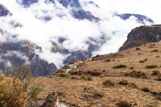 Beautiful view of the Colca Canyon with clouds and rugged cliffs in Cabanaconde, Arequipa, Peru.