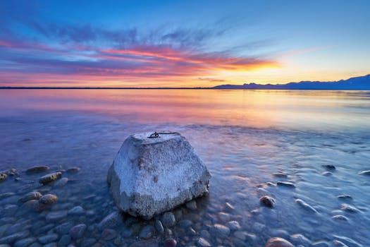Stunning sunrise over Lake Chiemsee in Bavaria with vivid reflections on the calm water.