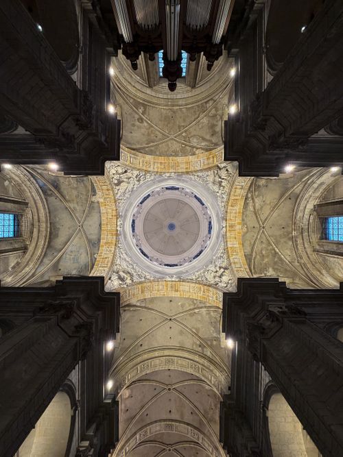 Free Intricate dome ceiling of a historic cathedral with ornate details and lighting. Stock Photo